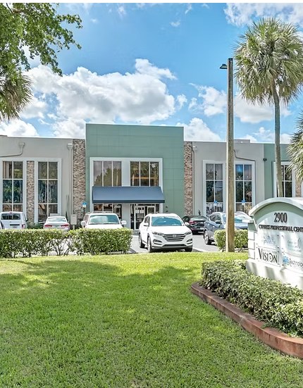 The two-story Cypress Professional Center building at 2900 W. Cypress Creek Rd. in Fort Lauderdale, with palm trees and a lawn out front