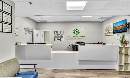 The front desk with the Reclamation Center logo on the wall behind it